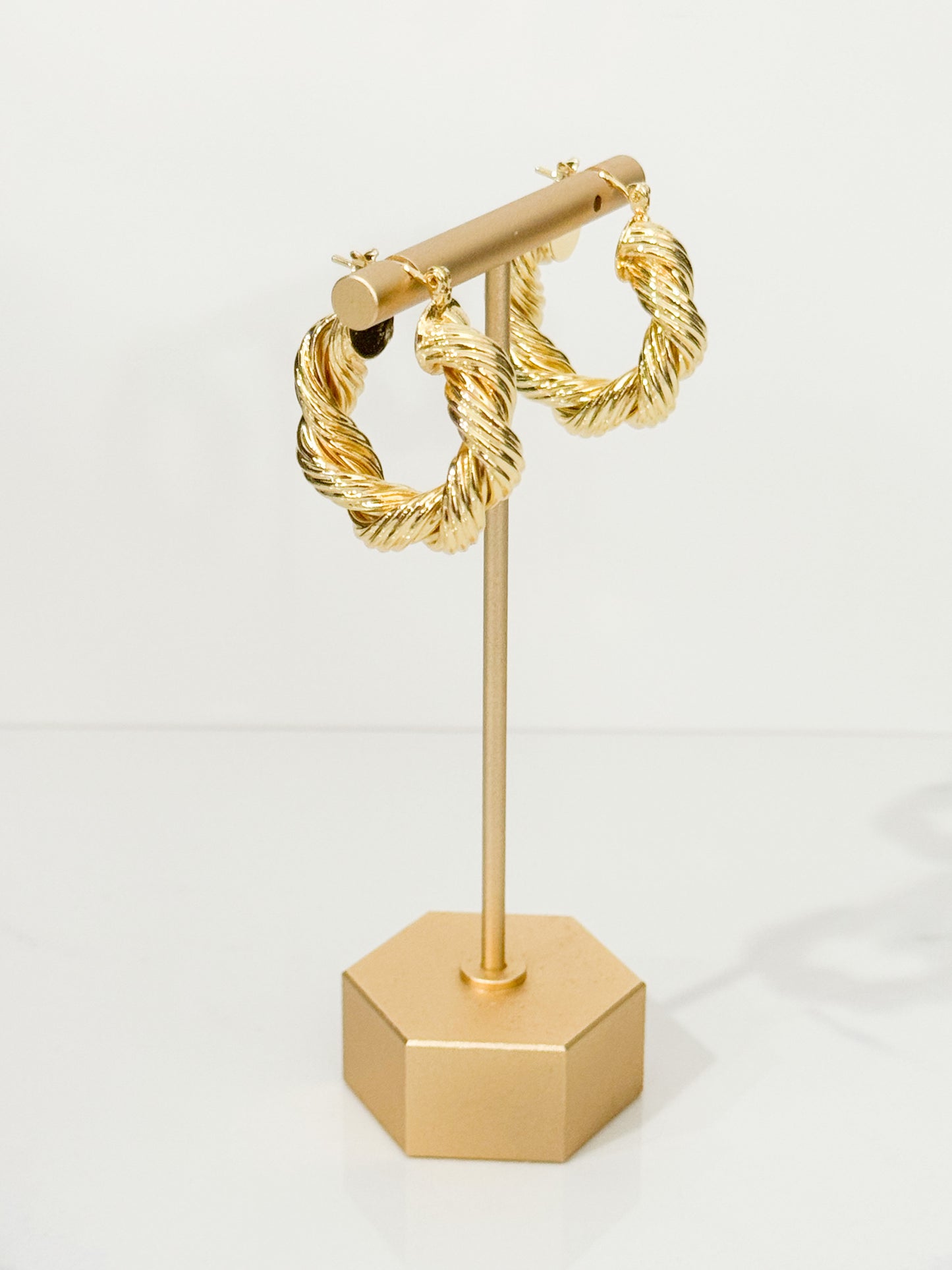 twisted hoop earrings in gold