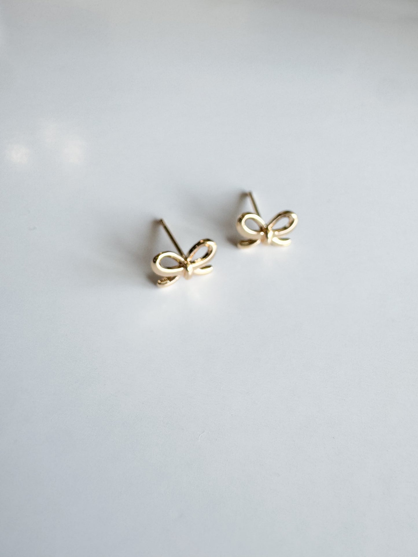 mini bow studs in gold