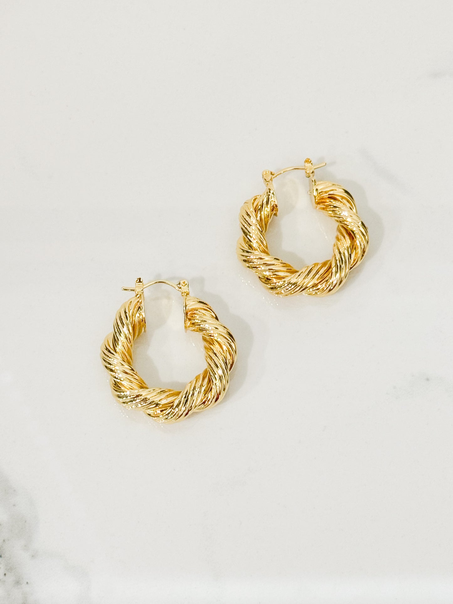 twisted hoop earrings in gold