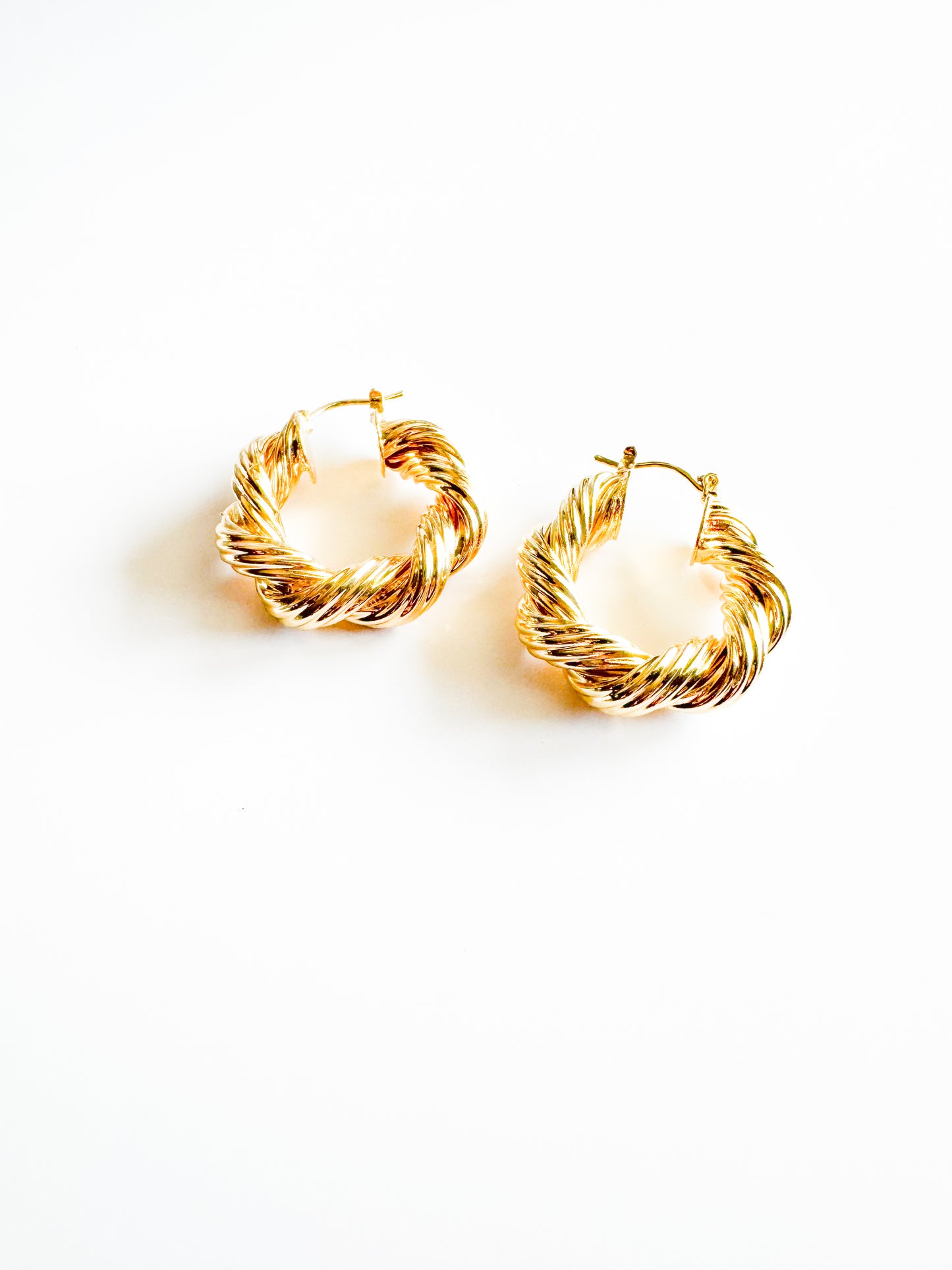 twisted hoop earrings in gold