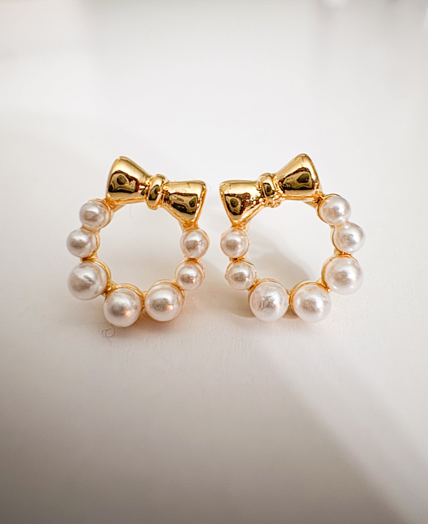 mini faux pearl with gold bow studs